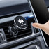 A round black car hook bracket with a silver edge, designed to attach to car vents, holding devices securely.