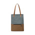 A convertible canvas backpack to tote bag in grey and brown, featuring two leather straps and a zippered pocket.