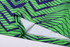 A vibrant green and navy patterned unisex long sleeve shirt featuring a V-neck design and soft fabric.