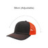 A black and orange mesh back trucker hat with an adjustable strap and a logo on the front.