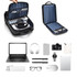 A polyurethane laptop backpack in black with a striped interior, containing a laptop, headphones, and various accessories.