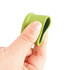 A drink bottle top with a green silicone wine stopper being held by a hand, showcasing its flexible design.
