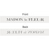 A grey soft ribbon featuring a logo on both sides, with elegant lettering in contrasting colours.