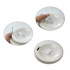 A coffee cup lid with a sliding opening mechanism in a light beige colour, featuring a hand demonstrating its use.