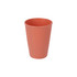 A wheat straw toothbrush cup in a coral colour with a ribbed texture and a logo.