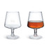 A brandy snifter in clear glass, with one empty and one filled with amber liquid, featuring a logo.