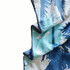 A hooded change towel in shades of blue and white with a palm leaf design, featuring a branded logo.