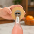 A drink bottle with a circular bamboo coaster bottle opener, showcasing natural wood tones and a sleek design.