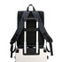 A navy blue business laptop backpack with adjustable straps resting on a silver suitcase.