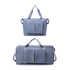 A foldable sports duffle bag in light blue with two front pockets and dual handles for carrying.