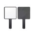 A handheld square mirror with a black handle and a reflective surface on one side and matte black on the other.