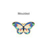 A moulded metal clip featuring a vibrant butterfly design with blue, green, red, and cream colours.