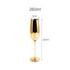 A stainless steel champagne flute in a shiny gold finish, measuring 22cm tall and 5cm wide.