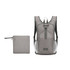 A large packable camping backpack in grey, alongside a small, matching storage pouch. The backpack features ergonomic straps and pockets.