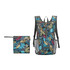 A large packable backpack in a multicoloured leaf pattern, with a smaller matching pouch beside it.