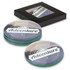 A set of four round glass coasters in various colours, displayed in a black box with a logo.