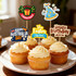 A tray of cupcakes topped with cream frosting, decorated with colourful party-themed toothpicks.