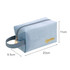 A soft blue cosmetic bag with a zipper closure and a handle, featuring a logo on the side.