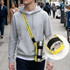 A drink bottle holder strap sling in yellow and black, featuring a logo, designed for carrying a water bottle.