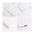 A white 5000mAh power bank with a built-in charging cable, featuring USB ports and a logo on the back.