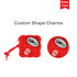 A red square silicone pouch with a paw print design and a round charm, both featuring a logo.