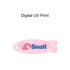 A fish-shaped hair clip in iridescent pink, featuring a logo in blue.