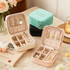 A set of PU leather jewellery boxes in mint green, black, cream, and pink, featuring various compartments for accessories.