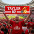 A fan holds a red banner in a stadium, surrounded by cheering supporters, showcasing a player and the Hall of Fame emblem.