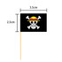 A toothpick flag with a black background featuring a skull and crossbones design in yellow and white, measuring 3.5cm by 2.5cm.
