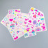 A collection of vibrant glow-in-the-dark temporary tattoos featuring hearts, rainbows, and various playful designs.