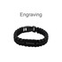 A black paracord bracelet featuring a metal plate and a clasp, suitable for custom engraving.