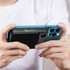 A blue power bank is attached to a smartphone, featuring a logo and a sleek design for charging convenience.
