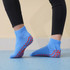 Low cut kids socks in light blue with red grip patterns on the soles. Includes a logo on the side.