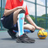 Knee high football socks in blue with black and red accents, featuring a towel bottom, paired with a red sports top.