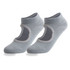 A pair of light grey open top yoga socks featuring a logo and non-slip grip on the sole.