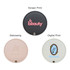 A round makeup mirror featuring three design options: black, pink, and cream with various prints and a logo.