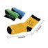 A pair of ankle socks in yellow with black accents, alongside two rolled pairs in green and blue. The socks feature a logo.