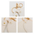A heart-shaped compact mirror in white with a keychain attachment and gold accents. Features a clasp and loop.