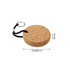 A round cork keyring with a diameter of 69mm, featuring a black cord and metal keyring attachment.