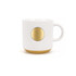A ceramic coffee mug in white with ribbed texture and a bronze medal accent at the front.
