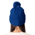 A blue Pom Pom Beanie Hat with a textured knitted design and a fluffy pom pom on top. Features branding on the hat.