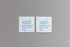 Two square pieces of textured seed paper in light grey with blue and yellow illustrations promoting zero waste.