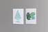 A large seed paper greeting card featuring a Christmas tree design and a green character illustration with a logo.