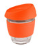 A glass coffee cup with a clear body and an orange silicone lid and band. It has a modern design and a logo.