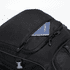 A black backpack featuring a zippered pocket with a passport partially visible inside. The backpack has a logo.