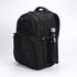 A black Fitzroy Backpack with a side pocket holding a drink bottle, featuring a logo on the front.