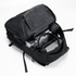 A black Fitzroy Backpack open to reveal compartments with a drink bottle, laptop, and headphones inside.