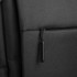 A black backpack featuring a zippered pocket and a black zipper pull, with a simple, sleek design.