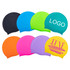 A selection of silicone swimming caps in black, blue, green, orange, pink, and purple, featuring a logo on one cap.