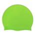 A bright green silicone swimming cap with a smooth surface and rounded shape, featuring a logo.